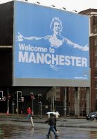A Manchester City FC poster bearing the face of new signing and former Manchester United striker Carlos Tevez, in the city centre.