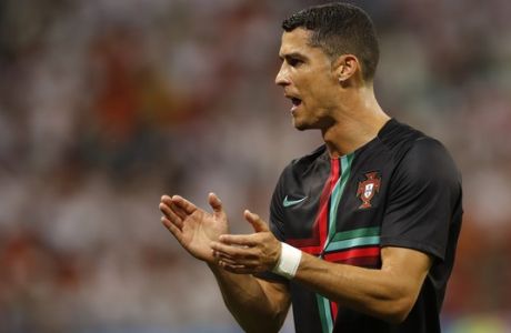 Portugal's Cristiano Ronaldo claps his hands as he takes part in the team warm up before the start of the group B match between Iran and Portugal at the 2018 soccer World Cup at the Mordovia Arena in Saransk, Russia, Monday, June 25, 2018. (AP Photo/Francisco Seco)