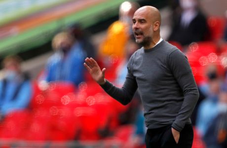 Manchester City's head coach Pep Guardiola gestures during the English League Cup final soccer match between Manchester City and Tottenham Hotspur at Wembley stadium in London, Sunday, April 25, 2021. (AP Photo/Alastair Grant)