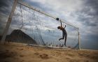 RIO DE JANEIRO, BRAZIL - JUNE 01: A boy practices defending penalty kicks with friends on Copacabana Beach on June 1, 2014 in Rio de Janeiro, Brazil. Brazil has won five World Cups, more than any other nation. The 2014 FIFA World Cup kicks off June 12 in Brazil. (Photo by Mario Tama/Getty Images)