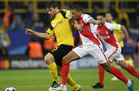 Dortmund's Sokratis Papastathopoulos, left, and Monaco's Kylian Mbappe challenge for the ball during the Champions League quarterfinal first leg soccer match between Borussia Dortmund and AS Monaco in Dortmund, Germany, Wednesday, April 12, 2017. (AP Photo/Martin Meissner)