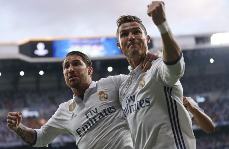 Real Madrid's Cristiano Ronaldo celebrates with Real Madrid's Sergio Ramos, left, after scoring the opening goal during the Champions League semifinals first leg soccer match between Real Madrid and Atletico Madrid at Santiago Bernabeu stadium in Madrid, Spain, Tuesday May 2, 2017. (AP Photo/Daniel Ochoa de Olza)