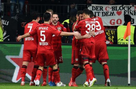 LEVERKUSEN, GERMANY - FEBRUARY 25:  Hakan Calhanoglu of Bayer Leverkusen  celebrates scoring the opening goal with team mates during the UEFA Champions League round of 16 match between Bayer 04 Leverkusen and Club Atletico de Madrid at BayArena on February 25, 2015 in Leverkusen, Germany.  (Photo by Dennis Grombkowski/Bongarts/Getty Images)
