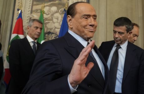 Forza Italia president Silvio Berlusconi waves to press as he leaves the Quirinale Presidential Palace after a meeting with Italian President Sergio Mattarella as part of a round of consultations with party leaders to try and form a new government, in Rome, Friday, Oct. 21, 2022. (AP Photo/Gregorio Borgia)