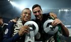Paris Saint-Germain's Kylian Mbappe, left, celebrates with Paris Saint-Germain's Spanish goalkeeper Sergio Rico the French Ligue 1 championship's trophy during a ceremony following the French L1 football match between Paris Saint-Germain (PSG) and Toulouse, Sunday, May 12, 2024 at the Parc des Princes stadium in Paris. (Franck Fife, Pool via AP)
