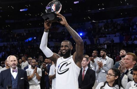 Team LeBron's LeBron James, of the Cleveland Cavaliers, holds the MVP trophy after his team defeated Team Stephen at the NBA All-Star basketball game, Sunday, Feb. 18, 2018, in Los Angeles. Team LeBron won 148-145. (AP Photo/Chris Pizzello)