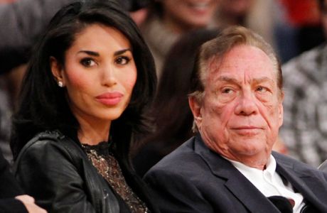 FILE - In this Dec. 19, 2010, file photo, Los Angeles Clippers owner Donald Sterling, right, and V. Stiviano, left, watch the Clippers play the Los Angeles Lakers during an NBA preseason basketball game in Los Angeles. NBA Commissioner Adam Silver is intent on moving quickly in dealing with the racially charged scandal surrounding Clippers owner Sterling. The NBA league will discuss its investigation Tuesday, April 29, 2014, before the Clippers play Golden State in Game 5 of their playoff series. (AP Photo/Danny Moloshok, File)
