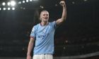 Manchester City's Erling Haaland celebrates after scoring his side's third goal during the English Premier League soccer match between Arsenal and Manchester City at the Emirates stadium in London, England, Wednesday, Feb.15, 2023. (AP Photo/Kin Cheung)