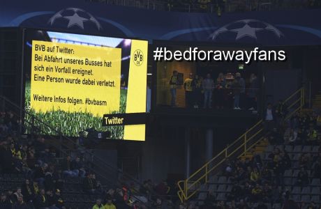 A digital display board informs the crowd of an incident involving the Borussia Dortmund team bus in the Signal Iduna Park in Dortmund, Germany, Tuesday,  April 11, 2017. The first leg of the Champions League quarter final soccer match between Borussia Dortmund and AS Monaco had been cancelled. (AP Photo/Bernd Thissen/dpa via AP)