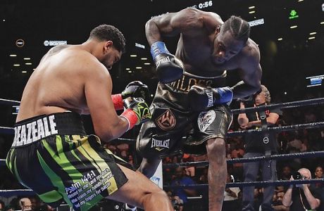 Deontay Wilder, right, knocks down Dominic Breazeale during the first round of the WBC heavyweight championship boxing match Saturday, May 18, 2019, in New York. Wilder stopped Breazeale in the first round. (AP Photo/Frank Franklin II)