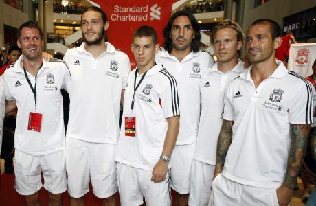 The Liverpool FC players, from left, Jaime Carragher, Andy Carroll, John Flanagan, Sotirios Kyrgiakos, Christian Poulsen and Raul Meireles pose during "Meet the Fans" session at a shopping mall in Kuala Lumpur, Malaysia, Friday, July 15, 2011.  The soccer club will play the Malaysia XI, a Malaysia League selection, at a friendly match on Saturday. (AP Photo/Lai Seng Sin)