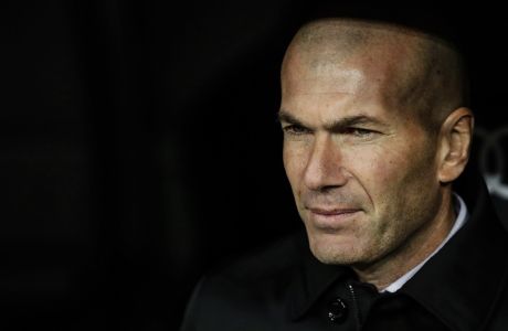 Real Madrid's head coach Zinedine Zidane sits on the bench during a Spanish Copa del Rey soccer match between Real Madrid and Real Sociedad at the Santiago Bernabeu stadium in Madrid, Spain, Thursday, Feb. 6, 2020. (AP Photo/Manu Fernandez)