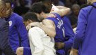 Los Angeles Clippers' Milos Teodosic, center, is carried off the court during the first half of an NBA basketball game against the Phoenix Suns on Saturday, Oct. 21, 2017, in Los Angeles. (AP Photo/Jae C. Hong)
