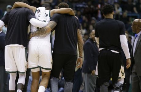 Milwaukee Bucks' Jabari Parker is helped off the court after getting injured against the Miami Heat during the second half of an NBA basketball game Wednesday, Feb. 8, 2017, in Milwaukee.  (AP Photo/Jeffrey Phelps)