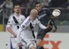 Ajax Amsterdam's Hakim Ziyech, right, fights for the ball with Legia's Tomasz Jodlowiec, left and Michal Pazdan during the Europa League round of 32 first leg soccer match between Legia Warsaw and Ajax Amsterdam at Stadion Wojska Polskiego in Warsaw, Poland, Thursday, Feb. 16, 2017. (AP Photo/Alik Keplicz)