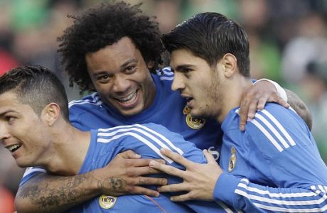 Real Madrid's Cristiano Ronaldo, left, celebrates with teammate Alvaro Morata, right, and Marcelo Vieira, centre, after scoring against Betis during their La Liga soccer match at the Benito Villamarin stadium, in Seville, Spain on Saturday, Jan. 18, 2014. (AP Photo/Angel Fernandez)