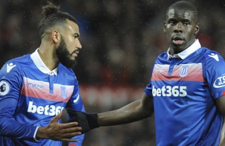 Stoke City's Kurt Zouma, right, taps hands with Stoke City's Eric Maxim Choupo-Moting after missing a chance to score during the English Premier League soccer match between Manchester United and Stoke City at Old Trafford in Manchester, England, Monday, Jan. 15, 2018. (AP Photo/Rui Vieira)
