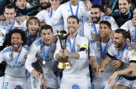 Real Madrid's Sergio Ramos holds the trophy after winning the Club World Cup final soccer match between Real Madrid and Gremio at Zayed Sports City stadium in Abu Dhabi, United Arab Emirates, Saturday, Dec. 16, 2017. (AP Photo/Hassan Ammar)