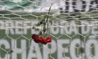 In this Tuesday, Nov. 29, 2016 photo, flowers hang from a soccer net in honor of Chapecoense soccer players who died in a plane crash, during a memorial at Arena Conda stadium in Chapeco, Brazil. Families are preparing to receive the bodies of the victims of this week's air tragedy in Colombia as experts develop a clearer picture of how things went so terribly wrong with a charter flight that slammed into the Andes mountains. (AP Photo/Andre Penner)
