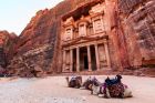 Camels in front of the Treasury at Petra the ancient City  Al Khazneh in Jordan lit by the sun