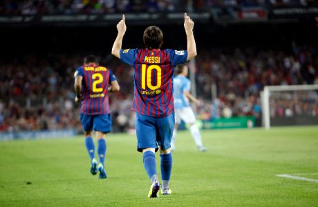 FC Barcelona's Lionel Messi from Argentina celebrates after scores against Osasuna during a Spanish La Liga soccer match at the Camp Nou stadium in Barcelona, Spain, Saturday, Sept. 17, 2011. (AP Photo/Emilio Morenatti)