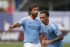 New York City FC's Andrea Pirlo, of Italy, center, directs teammate Shay Facey, of England, right, during the second half of an MLS soccer game against Orlando City SC at Yankee Stadium, Sunday, July 26, 2015, in New York.  New York defeated Orlando 5-3. (AP Photo/Jason DeCrow)  