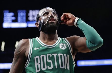 Boston Celtics' Kyrie Irving (11) adjusts his mask during the second half of the team's NBA basketball game against the Brooklyn Nets on Tuesday, Nov. 14, 2017, in New York. The Celtics won 109-102. (AP Photo/Frank Franklin II)