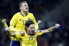 Sweden's Gustav Svensson and Viktor Claesson, top, celebrate at the end of the World Cup qualifying play-off second leg soccer match between Italy and Sweden, at the Milan San Siro stadium, Italy, Monday, Nov. 13, 2017. Four-time champion Italy has failed to qualify for World Cup; Sweden advances with 1-0 aggregate win in playoff. (AP Photo/Antonio Calanni)