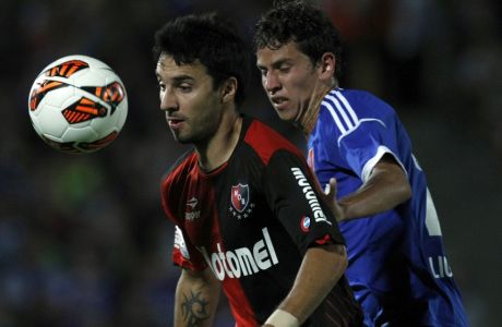 Chile's Universidad de Chile's Igor Lichnovsky, right, fights for a ball with Argentina's Newells' Old Boys's Ignacio Scocco during a Copa Libertadores soccer match in Santiago, Chile, Tuesday, March 12, 2013. (AP Photo/Luis Hidalgo)