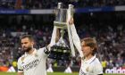 Real Madrid's Nacho, left, and Luka Modric hold up the Copa del Rey trophy prior to a Spanish La Liga soccer match between Real Madrid and Getafe at the Santiago Bernabeu stadium in Madrid, Spain, Saturday, May 13, 2023. (AP Photo/Manu Fernandez)