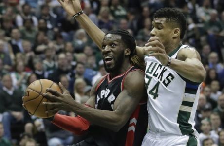 Toronto Raptors' DeMarre Carroll drives past Milwaukee Bucks' Giannis Antetokounmpo during the first half of Game 4 of an NBA first-round playoff series basketball game Saturday, April 22, 2017, in Milwaukee. (AP Photo/Morry Gash)