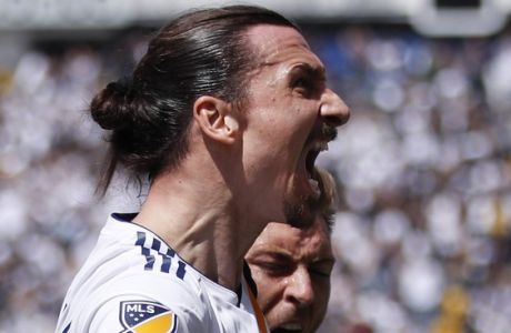 Los Angeles Galaxy's Zlatan Ibrahimovic, of Sweden, screams while celebrating his second goal of the game with Ashley Cole, right, and Dave Romney during the second half of an MLS soccer match against the Los Angeles FC Saturday, March 31, 2018, in Carson, Calif. The Galaxy won 4-3. (AP Photo/Jae C. Hong)