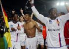 (LtoR) Lyon's players Ghanean midfielder Mickael Essien, midfielder Florent Malouda and midfielder Mahamadou Diarra celebrate after the French first league football match against Paris, 15 May 2004 at the Parc des Princes in Paris. PSG won the game 1-0. Lyon earns a third successive title of French league champion. AFP PHOTO JEAN-LOUP GAUTREAU