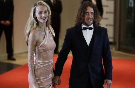 Carles Puyol, right, and girlfriend Vanessa Lorenzo, pose for photographers as they arrive at the hotel where Lionel Messi and his childhood sweetheart Antonella Roccuzzo will marry, in Rosario, Argentina, Friday, June 30, 2017. Some 260 guests, including teammates and former teammates of the Barcelona soccer star, will attend the highly anticipated ceremony. (AP Photo/Victor R. Caivano)