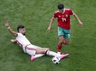 Iran's Ramin Rezaeian, left, and Morocco's Mbark Boussoufa, right, challenge for the ball during the group B match between Morocco and Iran at the 2018 soccer World Cup in the St. Petersburg Stadium in St. Petersburg, Russia, Friday, June 15, 2018. (AP Photo/Darko Vojinovic)