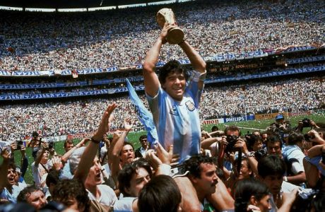 Diego Maradona of Argentina celebrates with the cup at the end of the World Cup soccer final in the Atzeca Stadium, in Mexico City, Mexico, on June 29, 1986. Argentina defeated West Germany 3-2 to take the trophy. (Ap Photo/Carlo Fumagalli)