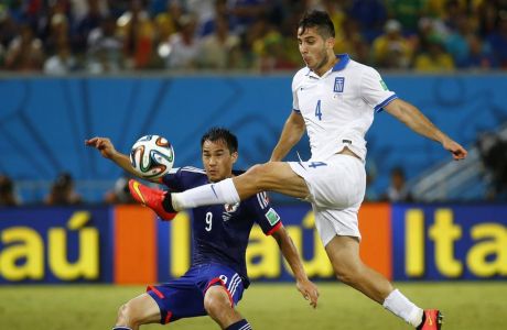 REFILE - CORRECTING IDENTITY OF JAPAN'S PLAYER 

Greece's Kostas Manolas (in white) kicks the ball next to Japan's Shinji Okazaki during their 2014 World Cup Group C soccer match at the Dunas arena in Natal June 19, 2014. REUTERS/Kai Pfaffenbach (BRAZIL  - Tags: SOCCER SPORT WORLD CUP)