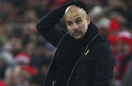 Manchester City's manager Pep Guardiola reacts during the English Premier League soccer match between Liverpool and Manchester City at Anfield Stadium, in Liverpool, England, Sunday Jan. 14, 2018. (AP Photo/Dave Thompson)