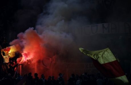 Roma's fans light flares as they wait for the start of  a Serie A soccer match between Roma and Atalanta at Rome's Olympic stadium, Saturday, April 12, 2014. (AP Photo/Gregorio Borgia)