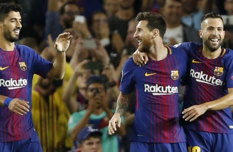 Barcelona's Luis Suarez, left, and Jordi Alba, right, celebrate with Lionel Messi who scored 3-0 during a Champions League group D soccer match between FC Barcelona and Juventus at the Camp Nou stadium in Barcelona, Spain, Tuesday, Sept. 12, 2017. (AP Photo/Francisco Seco)