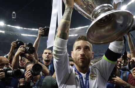 Real Madrid's Sergio Ramos celebrates with the trophy after winning the Champions League Final soccer match between Real Madrid and Liverpool at the Olimpiyskiy Stadium in Kiev, Ukraine, Saturday, May 26, 2018. (AP Photo/Matthias Schrader)