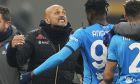 Napoli's head coach Luciano Spalletti, left, celebrates with team players as they won the Serie A soccer match between AC Milan and Napoli at the San Siro stadium in Milan, Italy, Sunday, Dec. 19, 2021. (AP Photo/Antonio Calanni)
