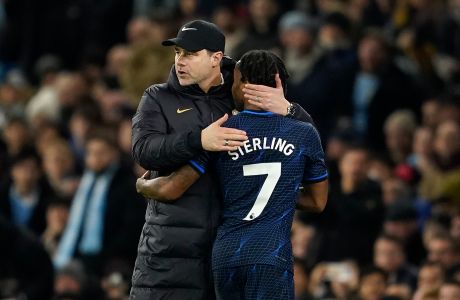 Chelsea's head coach Mauricio Pochettino greets Chelsea's Raheem Sterling after he was substituted during the English Premier League soccer match between Manchester City and Chelsea at the Etihad stadium in Manchester, England, Saturday, Feb. 17, 2024. (AP Photo/Dave Thompson)