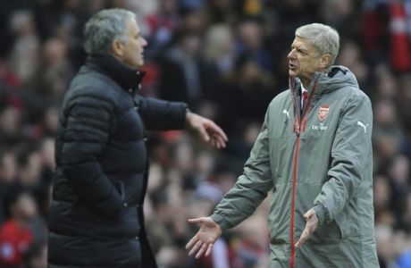 Arsenal manager Arsene Wenger, right, reacts along side Manchester United manager Jose Mourinho during the English Premier League soccer match between Manchester United and Arsenal at Old Trafford in Manchester, England, Saturday, Nov. 19, 2016. (AP Photo/Rui Vieira)