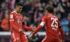 Bayern's Thomas Mueller, right, celebrates with Bayern's Joao Cancelo after scoring his side's opening goal during the Bundesliga soccer match between Bayern Munich and VfL Bochum 1848 at the Allianz Arena in Munich, Germany, Saturday, Feb.11, 2023. (AP Photo/Andreas Schaad)