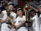 Dallas Mavericks' Dirk Nowitzki, Jason Kidd and Jason Terry hold up their trophies after Game 6 of the NBA Finals basketball game against the Miami Heat Sunday, June 12, 2011, in Miami. The Mavericks won 105-95 to win the series. (AP Photo/David J. Phillip)