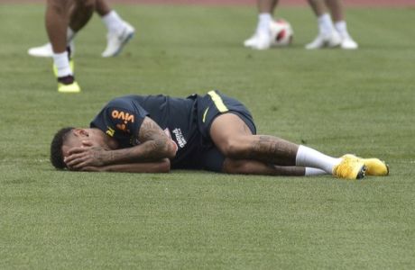 Brazil's Neymar lays on the pitch during a training session in Sochi, Russia, Wednesday, July 4, 2018. Brazil will face Belgium on July 6 in the quarterfinals for the soccer World Cup. (AP Photo/Ekaterina Lyzlova)