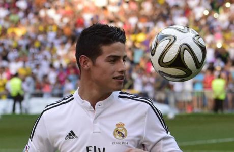 Colombian striker formerly at AS Monaco James Rodriguez controls a ball during his presentation at the Santiago Bernabeu stadium following his signing with Spanish club Real Madrid in Madrid on July 22, 2014.  Spanish media said Real paid about 80 million ($108m) for Rodriguez, making him one of the most expensive players ever. Neither club gave a figure, but Monaco said it was "one of the biggest transfers in football history."   AFP PHOTO / PIERRE-PHILIPPE MARCOUPIERRE-PHILIPPE MARCOU/AFP/Getty Images