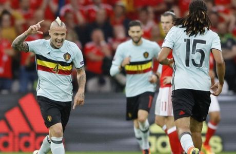 Belgium's Radja Nainggolan, left, celebrates after scoring the opening goal during the Euro 2016 quarterfinal soccer match between Wales and Belgium, at the Pierre Mauroy stadium in Villeneuve d'Ascq, near Lille, France, Friday, July 1, 2016. (AP Photo/Frank Augstein)