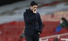 Arsenal's manager Mikel Arteta touches his face during an English Premier League soccer match between Arsenal and Southampton at the Emirates stadium in London, England, Wednesday, Dec. 16, 2020. (Peter Cziborra/Pool via AP)